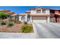 Charming two-story home with a well-manicured lawn and a two-car garage, offering great curb appeal at 4615 Stearman Dr, North Las Vegas, NV 89031