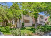 Inviting condo complex featuring lush landscaping and trees, creating a serene atmosphere at 4843 S Torrey Pines Dr # 101, Las Vegas, NV 89103