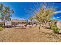 Expansive backyard featuring desert landscaping, mature trees, and a charming patio area perfect for outdoor entertaining at 4910 Marywood Ct, Pahrump, NV 89061