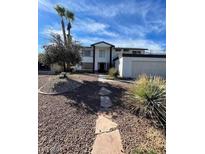 Inviting home featuring drought-resistant landscaping, desert flora, and a stone walkway leading to the entrance at 5243 Sunnywood Dr, Las Vegas, NV 89120
