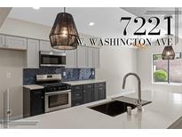 Beautiful kitchen featuring stainless steel appliances, modern countertops, and stylish light fixtures at 7221 W Washington Ave, Las Vegas, NV 89128
