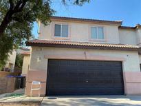 Two-story townhouse with a two-car garage and a red tile roof, offering comfortable suburban living at 728 Twilight Blue Ave, North Las Vegas, NV 89032