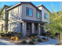 Beautiful two-story home featuring a well-manicured front yard, charming architecture, and great curb appeal at 7332 N Decatur Blvd # 2, North Las Vegas, NV 89084