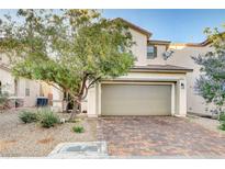 Charming two-story home with a two car garage, desert landscaping and brick paver driveway at 9846 Sunriver Meadows Ave, Las Vegas, NV 89148