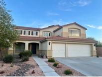 Charming two-story home featuring a two-car garage and well-maintained landscaping at 1921 Moonlight Bluff Ave, North Las Vegas, NV 89084