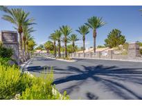 Gated community entrance featuring lush landscaping and beautiful homes in La Mancha Estates at 1953 Moyer Dr, Henderson, NV 89074