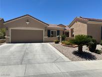 Charming single-story home featuring a desert landscape, two-car garage, and neutral-toned stucco exterior at 2365 Wisconsin Dells Dr, Henderson, NV 89044