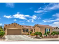 Charming single-story home boasts a well-manicured yard and a two-car garage at 2365 Wisconsin Dells Dr, Henderson, NV 89044
