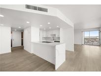 Bright living room features wood floors, modern lighting, and an open floor plan with city views at 3111 Bel Air Dr # 24G, Las Vegas, NV 89109
