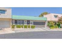 Charming single-story home featuring a green tile roof and well-manicured front yard landscaping at 3815 Atlantis St, Las Vegas, NV 89121
