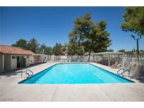 A community pool is surrounded by a large deck, mature trees and shade structures offering residents a recreational space at 459 Kelsford Dr, Las Vegas, NV 89123