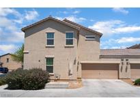 Two story home featuring an attached garage with neutral stucco and tile roof at 4610 Lime Straight Dr, Las Vegas, NV 89115