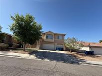 Inviting two-story home with a well-maintained lawn and two-car garage, perfect for Gathering living at 6351 Davidson Ct, Las Vegas, NV 89110