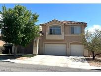 Two-story home with a two-car garage and tile roof, complemented by mature landscaping at 6351 Davidson Ct, Las Vegas, NV 89110