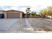 Charming single-story home featuring a two-car garage and well-maintained front yard at 6608 Burgundy Way, Las Vegas, NV 89107