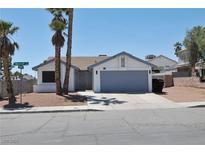 Charming single-story home featuring desert landscaping, palm trees, and a two-car garage at 6929 Montcliff Ave, Las Vegas, NV 89147