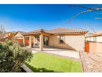 A backyard with an inviting covered patio and a small patch of artificial turf at 766 Topocoba St, Las Vegas, NV 89178