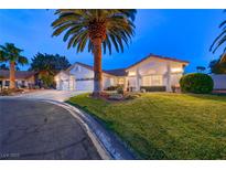 Charming single-story home with a well-manicured lawn and a towering palm tree in the front yard at 7670 Descanso Ln, Las Vegas, NV 89123