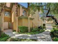 Inviting entryway with a well-maintained lawn and mature palm trees at 8717 Red Brook Dr # 201, Las Vegas, NV 89128