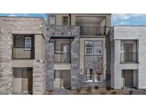 Modern three-story townhome with private balconies and stone accents at 899 Apatite Pl # Lot 61, Henderson, NV 89011