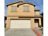 Two-story home featuring a two-car garage and neutral stucco exterior at 9844 Ashton Pines Ct, Las Vegas, NV 89147
