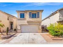 Charming two-story home featuring a two-car garage and low-maintenance desert landscaping under a bright blue sky at 10642 Dawns Mist Ave, Las Vegas, NV 89129