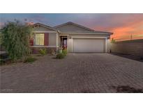 Charming single-story home featuring a brick driveway and attached two-car garage at 129 Barton Bay Ave, North Las Vegas, NV 89031