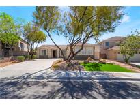 Charming single-story home with desert landscaping, mature shade trees, and a spacious driveway at 1387 Minuet St, Henderson, NV 89052