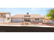 Charming single-story home featuring a landscaped front yard and a two-car attached garage at 1505 Irene Dr, Boulder City, NV 89005