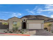 Charming single-story home featuring a tiled roof, two-car garage, and drought-tolerant landscaping at 161 Cabo Cruces Dr, Henderson, NV 89011