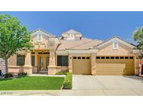 Charming single-story home with a well-manicured lawn, desert landscaping and a three-car garage at 2150 Ponticello Dr, Henderson, NV 89052