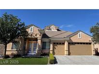 Inviting single-story home with a two-car garage, manicured lawn, and elegant double-door entry at 2150 Ponticello Dr, Henderson, NV 89052