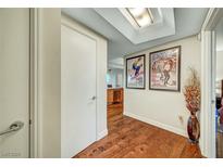 Hallway with hardwood floors and decorative artwork on the walls at 222 Karen Ave # 601, Las Vegas, NV 89109
