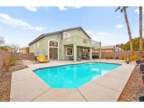 Home's refreshing pool features a spacious concrete deck perfect for relaxing and entertaining at 2250 Tedesca Dr, Henderson, NV 89052