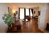 Inviting living room featuring hardwood floors, comfortable seating, and natural light from the windows at 230 E Flamingo Rd # 129, Las Vegas, NV 89169