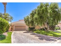 Charming one-story home featuring a paver driveway and a two-car garage at 27 Via Paradiso St, Henderson, NV 89011