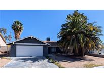 Charming single-story home featuring a two-car garage and mature landscaping, including two palm trees at 3020 Wilmington Way, Las Vegas, NV 89102