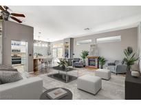 Bright living room featuring sleek furniture, a fireplace, and an open layout with seamless access to the kitchen at 3112 Haddon Dr, Las Vegas, NV 89134