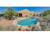 Inviting backyard pool with mature landscaping and lounge area is ideal for entertaining at 3112 Haddon Dr, Las Vegas, NV 89134