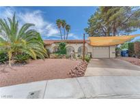 Charming single-story home with desert landscaping, shade covering, and an attached two-car garage at 3158 La Luna Cir, Henderson, NV 89014