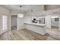 Modern kitchen features stainless appliances, white cabinets, and a large breakfast bar at 3400 Cabana Dr # 1048, Las Vegas, NV 89122