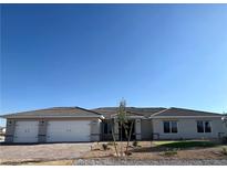 Beautiful single story home with a three car garage, desert landscaping, and a tile roof at 3791 Soplo Rd, Pahrump, NV 89048