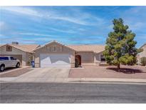 Charming single-story home with a well-maintained front yard and a two-car garage at 394 Lombardy Cir, Henderson, NV 89015