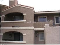 Two-story condo with balconies and neutral-colored stucco exterior at 5220 Mission Carmel Ln # 207, Las Vegas, NV 89107