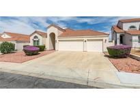Charming single-story home with a two-car garage, desert landscaping, and a red tile roof at 6 Sandwedge Dr, Henderson, NV 89074