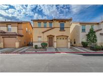 Charming two-story home featuring a terracotta roof, attached garage, and quaint front yard at 687 Porchtown Ave, Las Vegas, NV 89183