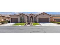 Beautiful home exterior boasts mature landscaping, tile roof, three-car garage, and desert accents at 7228 Fern Meadow St, Las Vegas, NV 89149