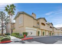 Inviting condo complex featuring well-maintained landscaping and private garage spaces at 8737 Red Brook Dr # 201, Las Vegas, NV 89128