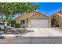 Charming single-story home featuring a two-car garage, desert landscaping, and a welcoming facade at 8934 Libertyvale Dr, Las Vegas, NV 89123