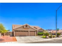 Charming single-story home featuring a three-car garage and desert landscaping at 1044 Spanish Needle St, Henderson, NV 89002